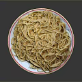 Yellow noodles on white plate with red rim against black background
