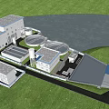 Modern Industrial Plant With Circular Treatment Tanks Near Waterbody And Green Surroundings