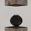 Black Ceramic Vessel Displayed On Wooden Base With Overhead Light In Minimalist Design