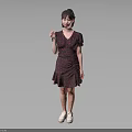 Woman In Red Floral Dress Standing Against Gray Background Holding Small Object With White Shoes