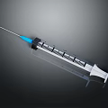 Medical Syringe With Blue Plunger Needle And Graduation Marks On Dark Background