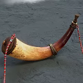 Handcrafted Wooden Horn Musical Instrument With Intricate Carved Patterns And Red White Beaded Strings