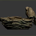 Two Bird Sculptures Perched On Woven Bird Nest Against Dark Background