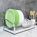 Kitchen Cabinets With Dish Rack Featuring Green White Plates And Wooden Spoons On Marble Countertop