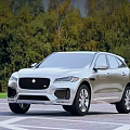 Silver Jaguar SUV Parked On Outdoor Lot With Trees
