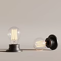 Vintage Filament Light Bulbs With Transparent Glass And Black Base Standing And Lying