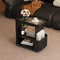 Modern Black Side Table With Flowers Coffee Cup Wine Bottle Radio And Books On Wheels