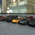 Multiple Luxury Sports Cars in Various Colors Parked Together with Urban Lights Background