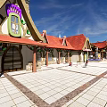 Scenic Public Square With Traditional Buildings Colorful Artworks Domes And Mountain Views