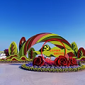 Decorative Flower Bed Planters With Rainbow Shaped Structure Roses And Green Leaves Under Blue Sky