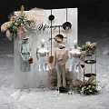 Stylish Retail Clothing Display With Mirror Sign Mannequins Floral Decor And Apparel