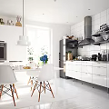 Modern Open Concept Kitchen Interior With White Cabinets Island Counter And Dining Chairs