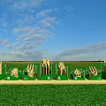 3D Letters Installation on Green Grassland Under Blue Sky with Clouds