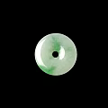 Round Green And White Jade Pendant With Central Black Hole On Black Background