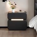 Sleek Black Modern Nightstand With Glowing Accent Doll Figure And Book By Bed