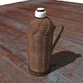 Woven Rattan Thermos Flask Placed On Wooden Floor With Open Field And Sky