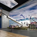 Historical Naval Cannon Display In Exhibition Space With Naval Battle Mural And Wooden Flooring