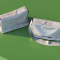 Two Light Colored Fabric Bags with Adjustable Shoulder Straps on Green Tabletop
