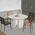 Modern White Round Dining Table Set With Different Colored Chairs Metal Legs And White Cabinets