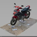 Red And Black Motorcycle Displayed On Platform With Small Tags