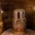 Ornate Multi Tiered Stone Columns With Architectural Details In Ancient Cave Interior