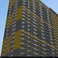 Modern High Rise Building with Yellow Gray Facade and Hinged Doors on Balconies
