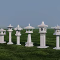 Multiple Traditional Stone Outdoor Lanterns Standing On Green Grass Field