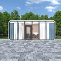 Modern Guesthouse Building With Large Glass Windows Paved Stone Courtyard And Lush Green Trees