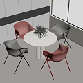 White Round Table with Red and Dark Gray Chairs and Potted Plant in Modern Interior