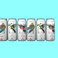 Canned Drinks With Colorful Bird And Fruit Designs On Light Blue Background