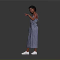 A woman in blue checkered jumpsuit pointing against gray background with white shoes