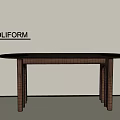 Round Wooden Dining Table with Modern Design by POLIFORM Against Light Colored Wall
