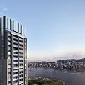 Modern High Rise Building Along Waterfront Featuring Distant City Skyline and Mountains