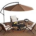 Outdoor Chairs With White Cushions Around Fire Pit Table On Wooden Deck And Brown Umbrella