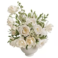 Elegant White Flowers Arrangement In White Vase With Green Leaves And Small Blossoms