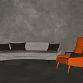 Gray Sectional Sofa with Black Cushions and Orange Armchair Against Gray Textured Wall and Floor