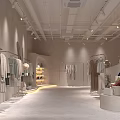 Light Colored Clothing Store Interior With Clothes Racks Display Shelves And Soft Lighting