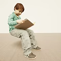 Man Sitting On The Floor Reading A Book Wearing Green Shirt And Gray Pants