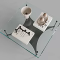 Modern Coffee Table With Glass Top Metal Legs And Decorative Items On Surface