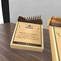 Two Golden Boxes of Daily Life Supplies with Elegant Design on Wooden Surface