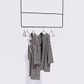 Gray Casual Clothes Hanging On Black Metal Hanger Rack Against White Background