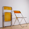 Two Folding Leisure Chairs With Yellow Seat Backrest And Chrome Metal Frame Against Wall