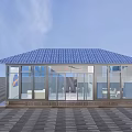 Modern Glass Sunroom Structure With Blue Roof And Transparent Walls On Black Floor