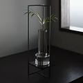 Modern Black Metal Frame Side Table with Clear Glass Vase and Green Plant