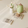 Cozy Tabletop Arrangement With White Vase Tulips Green Kettle Coffee Cup And Books