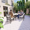 Cozy Courtyard Garden Outdoor Space With People Gathering Around Table And Green Plants