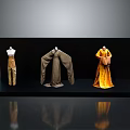 Clothing Display On Black Platform Featuring Mannequins With Brown Pants Gray Robe And Yellow Dress