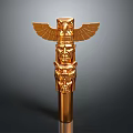 Golden Totem Pole Sculpture With Eagle Wings And Multiple Facial Carvings