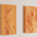 Two Orange Wavy Carved Wall Decor Pieces on Light Colored Wall