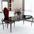 Elegant Black Dining Table with Red High Back Chair and Floral Centerpiece